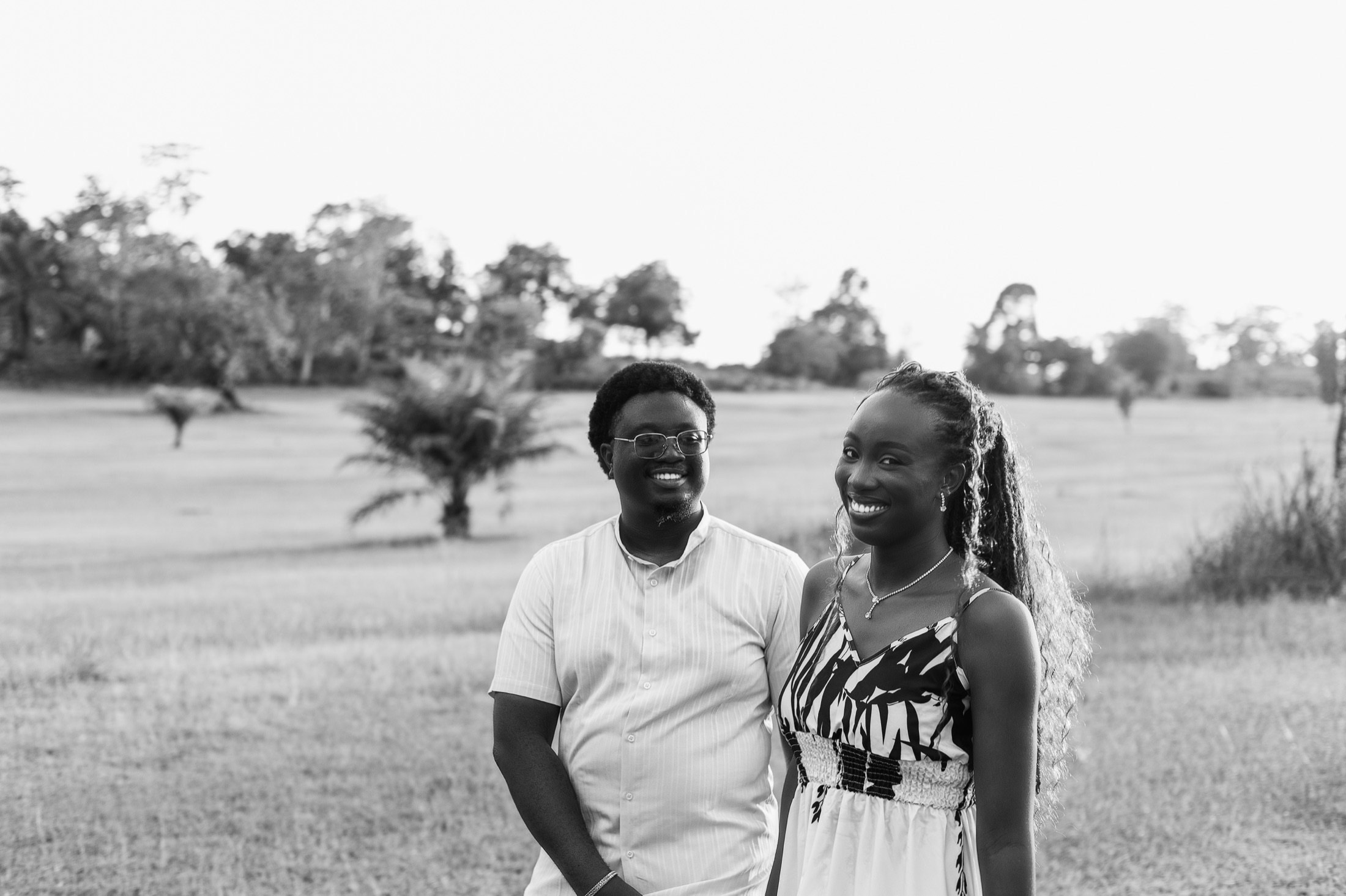 A black and white portrait of Esther-Praise and Jeremiah smiling